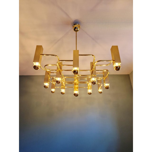 Large brass chandelier, designed by gaetano sciolari for the belgian manufacturer boulanger, 1970s. this designer...