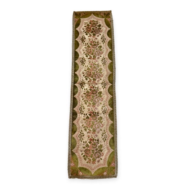 Vintage Gobelin-style table runner featuring raised pink and mauve roses, olive-green borders and metallic looped trim....