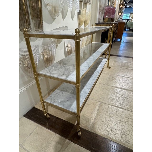 The Custom French Directoire Style Brass and Marble Server is a luxurious and elegant piece of furniture. Made with brass...