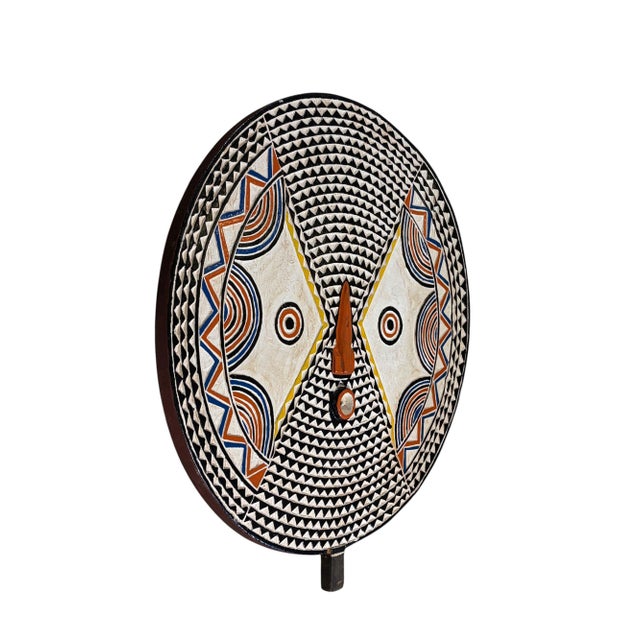 This striking vintage Bobo sun mask from Burkina Faso is hand-carved from wood and finished with an aged, multi-colored...