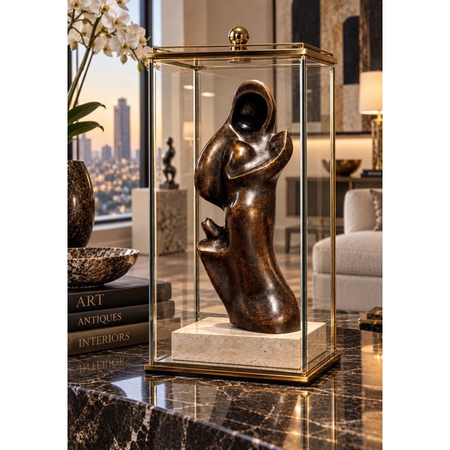 This is a modernist bronze sculpture depicting a stylized human form with a hollowed-out head and undulating, organic...