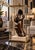 This is a modernist bronze sculpture depicting a stylized human form with a hollowed-out head and undulating, organic...