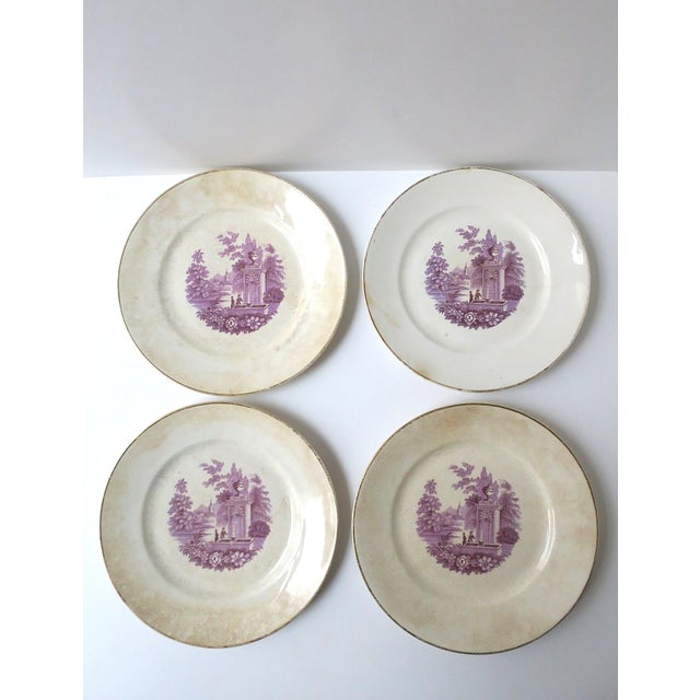 A set of four (4) American transferware dinner plates by Homer Laughlin, each featuring a magenta‑toned Gothic and...