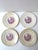 A set of four (4) American transferware dinner plates by Homer Laughlin, each featuring a magenta‑toned Gothic and...
