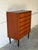 This tall dresser features six spacious drawers and clean architectural lines. Elevated on slender tapered legs, it offers...