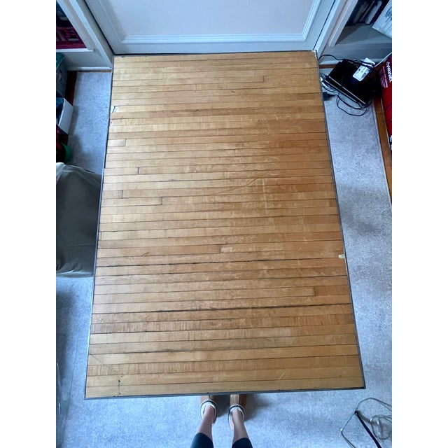 One-of-a-kind industrial desk or worktable featuring a substantial reclaimed bowling alley lane top paired with a dramatic...