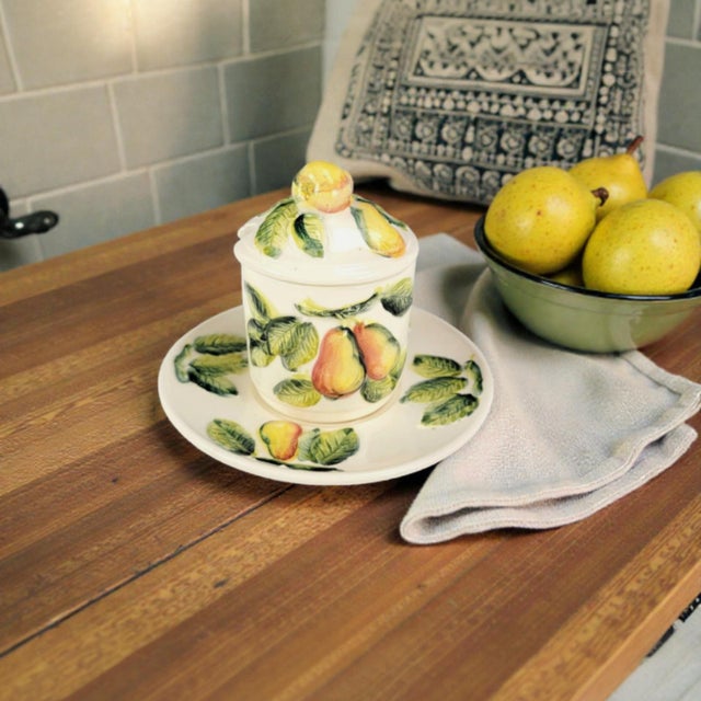 This Italian ceramic jam jar with matching saucer is executed in a trompe l’oeil pear motif, modeled in relief and...