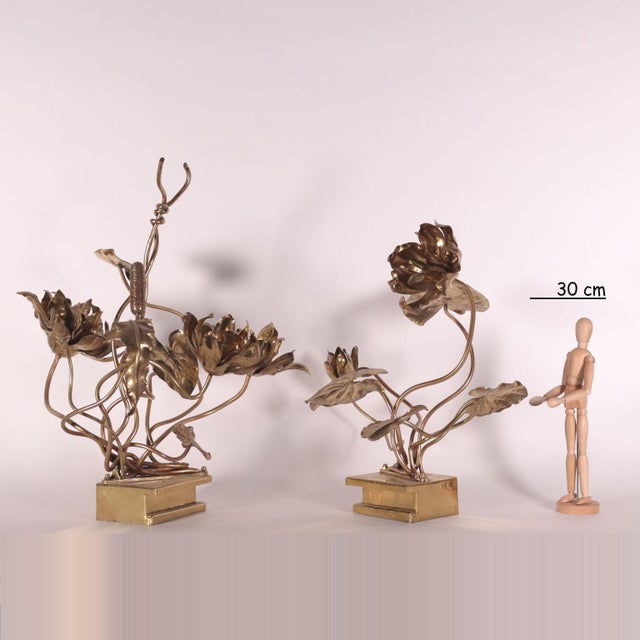 Pair of brass sculptures with flowers and leaves. In the manner of Maison Jansen. This piece is attributed to the...