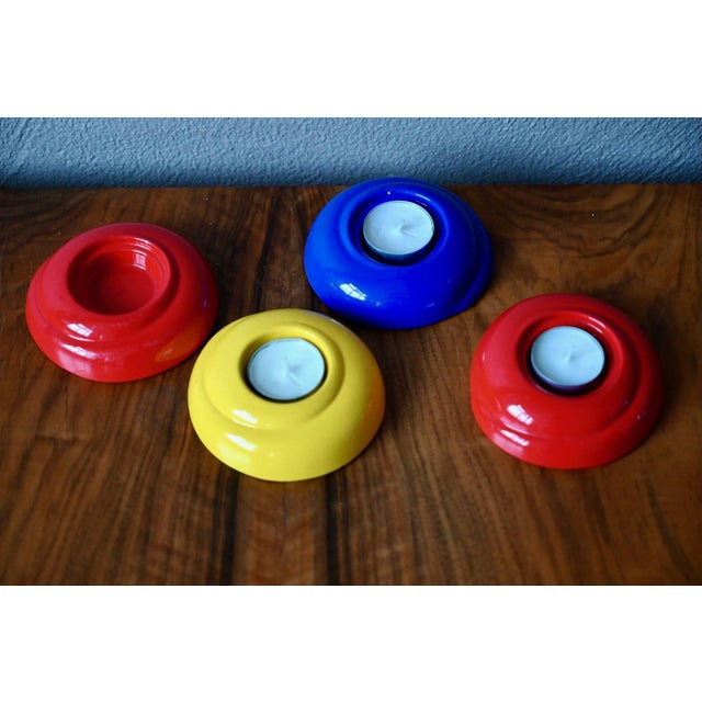 Cheerful and colorful, this set of four glazed ceramic candleholders evokes the pop spirit of the 1980s. Made in Germany...