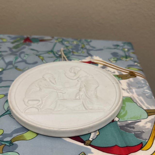 This piece is a classic Royal Copenhagen (or Bing & Grøndahl) bisque porcelain wall plaque titled "Winter". It is part of...