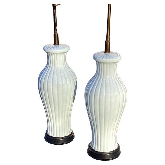 Pair of Mid Century White Ceramic Melon Form Table Lamps. The lamps measure 30” to the top of finial. They measure 19.5 to...