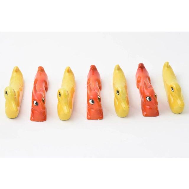 Art Deco ceramic hand-painted knife rests. Stamped Germany and numbered. Four yellow ducks. Three orange bunny rabbits