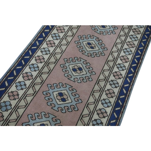 Introduce a touch of vintage elegance to your home with this 1960s Pink & Blue Geometric Design Handwoven Wool Vintage...