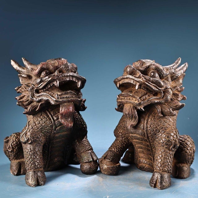 This is a matching pair of cast bronze figurines in the form of Qilin (mythical hooved chimeras), featuring high-relief...