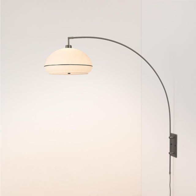 The Morelli Wall Mounted Arc Lamp is a modern lighting solution designed by Peter Morelli in 1960. It features a sleek...