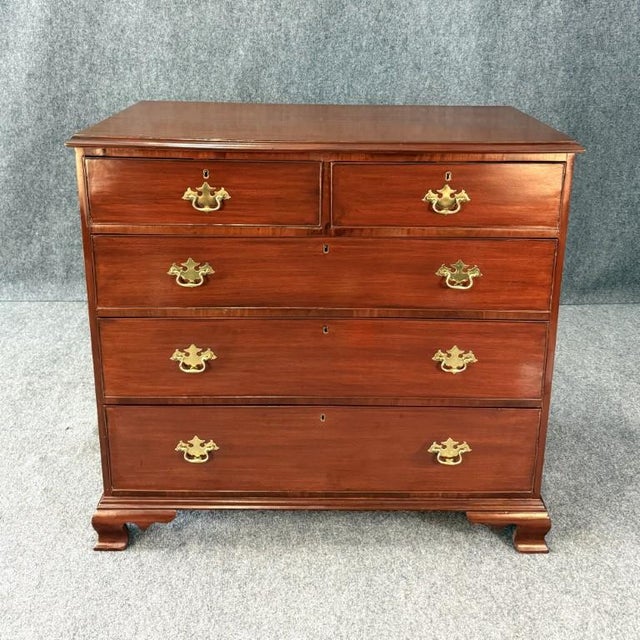 This 19th century five-drawer mahogany chest features a clean, well-proportioned form with a rich, warm finish and classic...
