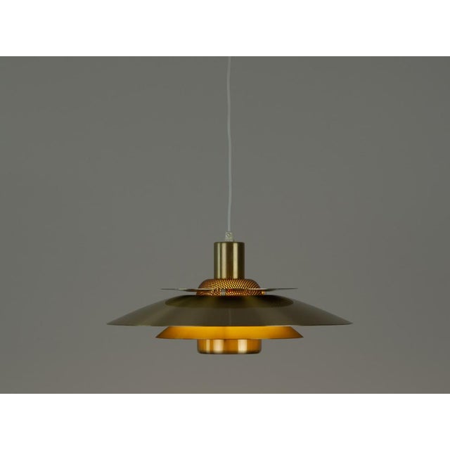 This lamp was designed by Danish designer Kurt Wiborg and manufactured by Jeka. The lamp's form is based on the principle...