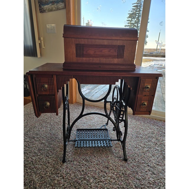 Striking late 19th–early 20th century German treadle sewing machine, branded “Favorite,” mounted in its original wooden...