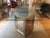 This is one very chic, high-end table. The base features 2 triangular pedestals with mirrors and beading on all 3 sides....