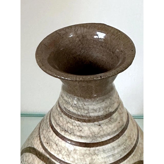 A small antique Korean Buncheong stoneware vase from early Joseon Dynasty circa 16th century. The vase is of a classic...