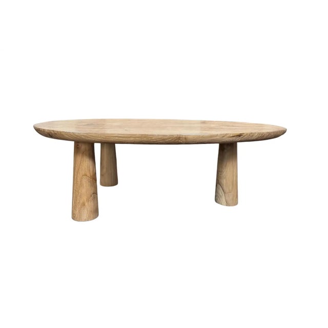 A sculptural side table crafted from solid teak wood, defined by its balanced proportions and refined, architectural form....
