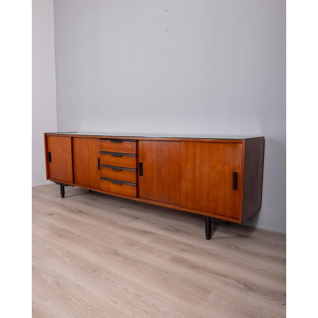 Teak wood sideboard with black wood details and glass top, Italian design, 1960s.