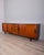 Teak wood sideboard with black wood details and glass top, Italian design, 1960s.