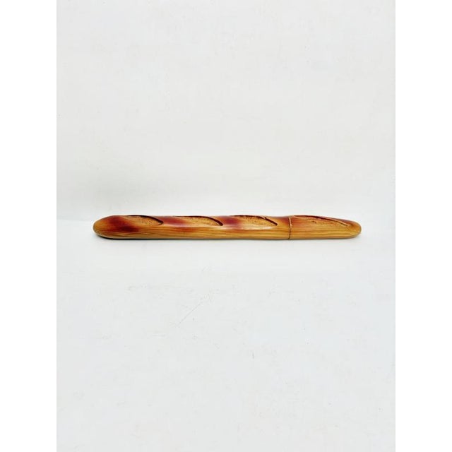 A French knife block from the 1970s, crafted from solid carved wood, inspired by the iconic shape of the baguette. The...