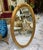 Oval Wall Mirror With Floral Center Detail & Gold Leaf Frame For Sale - Image 4 of 5