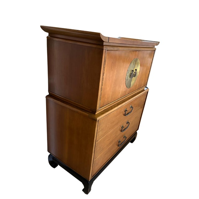 A beautifully crafted Kent-Coffey “Amerasia” walnut chest on chest, an iconic Mid-Century Modern design produced in the...