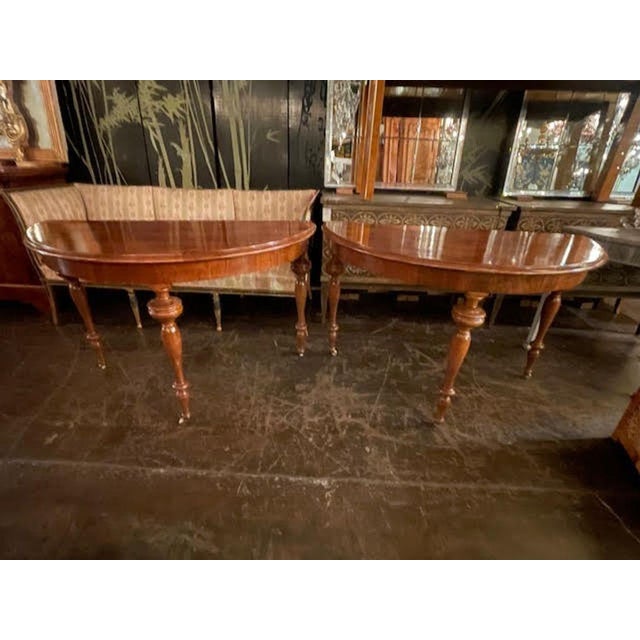 The pair of 19th c. Continental Walnut Demi-lune Consoles is a set of elegant and sophisticated furniture pieces that...