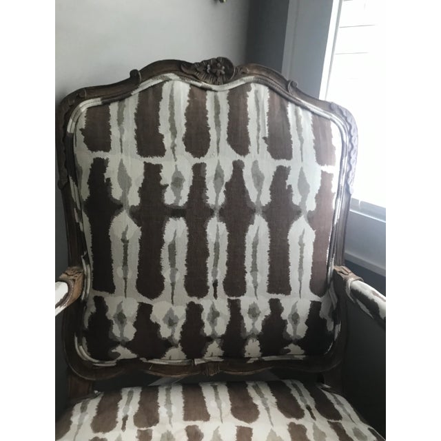 Lovely carving all around on this lovely Louis chair. Upholstered in a contemporary fabric of brown, white and gray cotton...