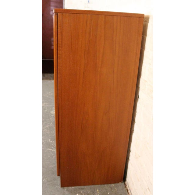 Vintage Danish Modern teak armoire, crafted in the mid-20th century with clean lines and warm, richly grained teak. The...