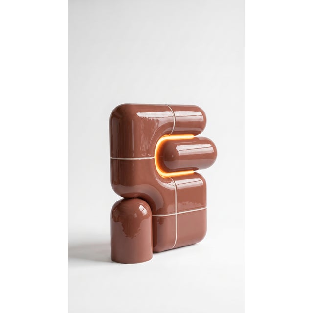 The smallest lamp in the collection, and often the first one people reach for. Its folded form hides the source entirely,...