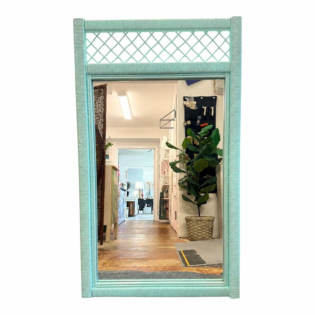 A charming vintage rattan mirror with a distinctly Palm Beach aesthetic. The frame features beautifully wrapped rattan...