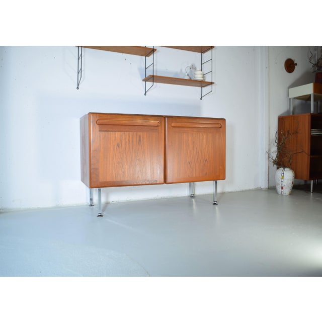 This is a high-quality teak chest of drawers from Denmark. The chest was manufactured in the 1970s. It features warm teak...
