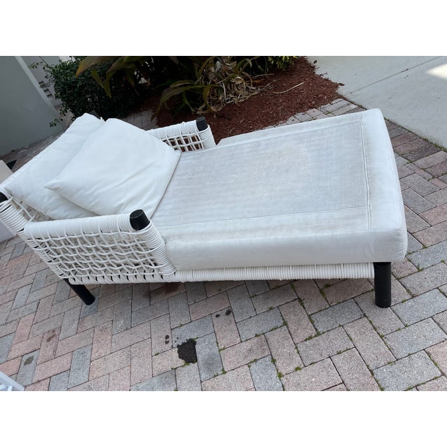 Modern design woven chaise lounge with mattress and pillow.