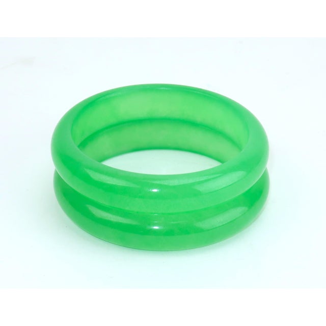 A pair of lovely green glass bracelets with the look and feel of jadeite. The glass practically glows with a vibrant...