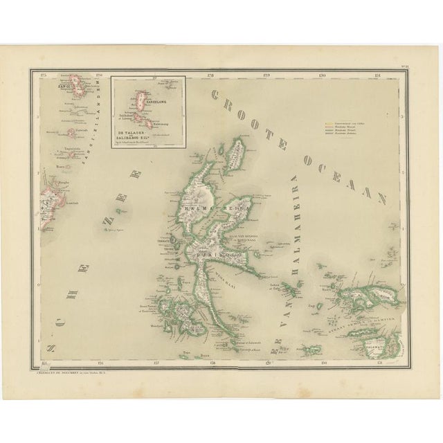 This finely detailed antique map depicts the northern moluccan islands with halmahera (gilolo) at its center, including...