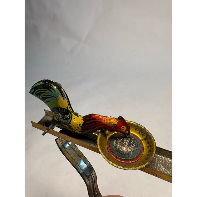 This is a super fun vintage squeeze-action toy made of brightly lithographed tin, featuring two very hungry roosters. This...