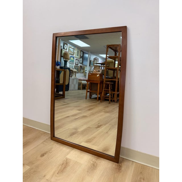This handsome vintage United Furniture mid-century modern curved walnut mirror is a clean and well-crafted MCM decorative...