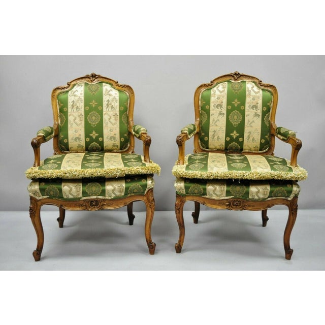 Pair of Early 20th Century French Louis XV Style Green and Gold Walnut Fauteuils Arm Chairs. Item features green and gold...