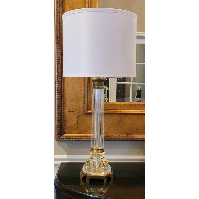 With a clear columnar form of Italian Murano glass and brass accents, here is a Mid-Century example of Hollywood Regency...