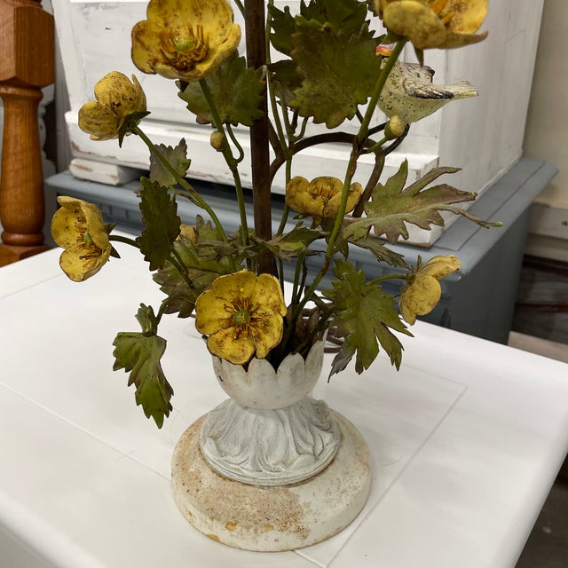Unique metal table lamp has an array of yellow flowers & leaves with several small birds perched on the limbs. The base...