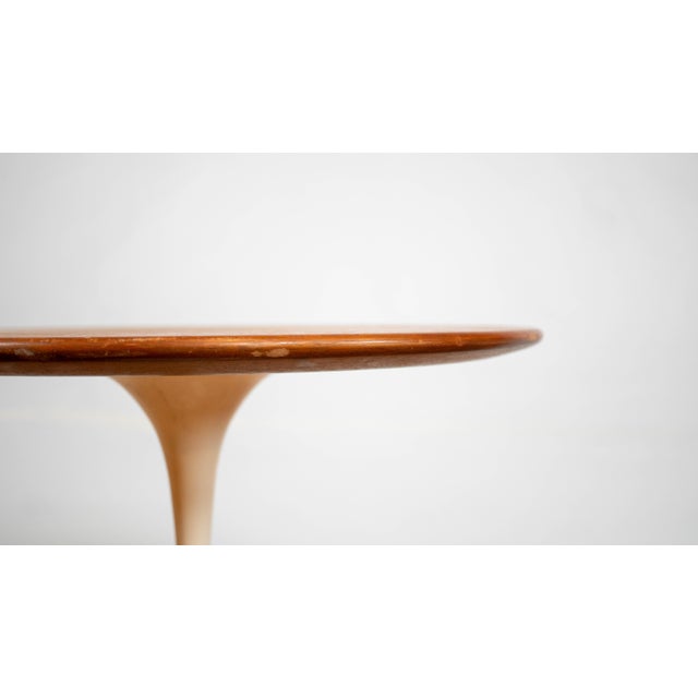 Vintage Eero Saarinen for Knoll International tulip side table with walnut veneer top and white base, circa 1970s. From...