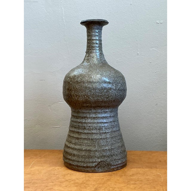 This vintage studio pottery vase is a refined example of mid-century ceramic craftsmanship, distinguished by its...
