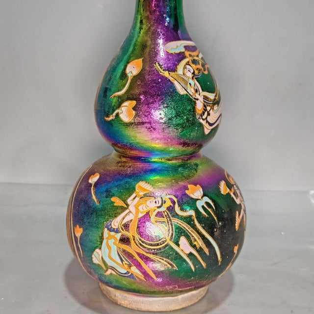 Add a striking focal point to your interior with this captivating vintage-style gourd vase. The double-gourd shape is...
