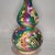 Add a striking focal point to your interior with this captivating vintage-style gourd vase. The double-gourd shape is...