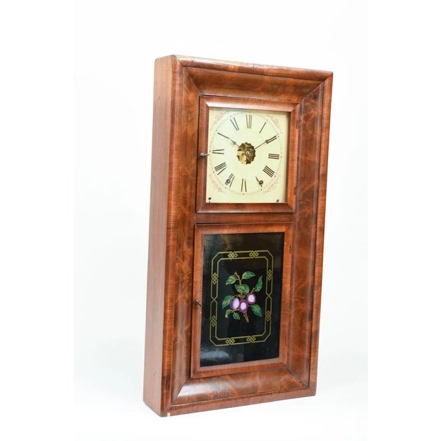 Ansonian 1842 American Ogee burled walnut case hanging wall clock with reverse painting on glass in the bottom panel....
