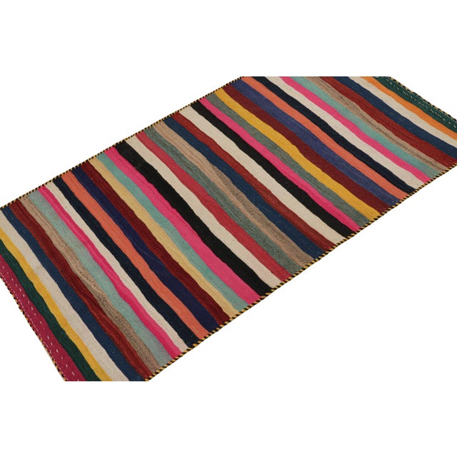 This vintage 4x8 Persian Tribal kilim is handwoven in wool, and originates circa 1950-1960. On the Design: This piece...